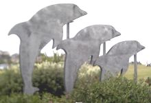 Metal sculpture of three dolphins
