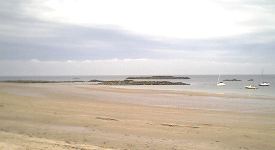 View to the West, with rocky outcrops on foreshore